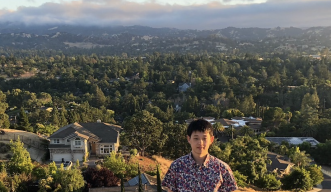 Photo of Jun with mountains in the background