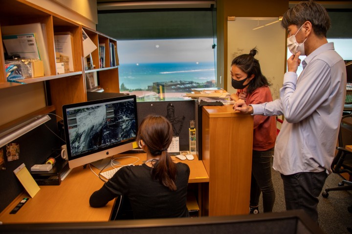 Research Assistant Kazumi Inoha shows simulations of the path of the pumice following the August eruption.