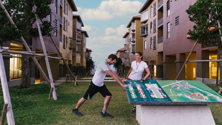 village center with two people by standing by map sign