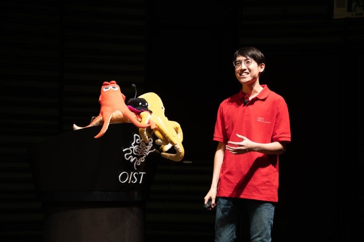 An OIST resercher giving a lecture.