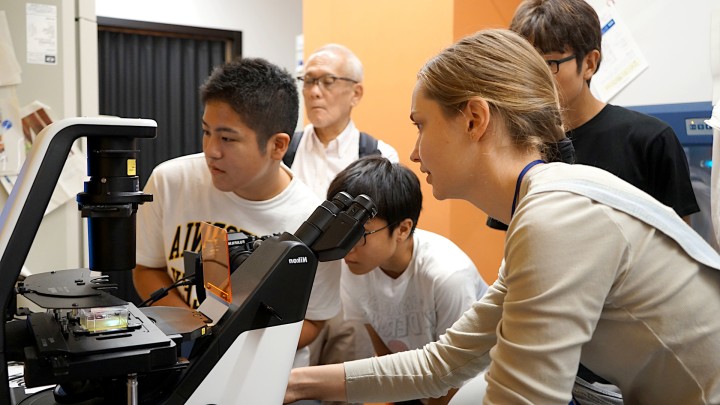 students looking at microscope