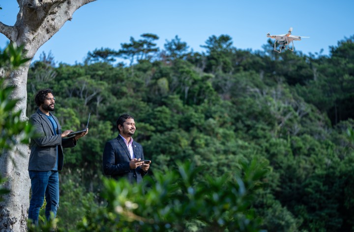 The Vyorius team flying their drone on campus