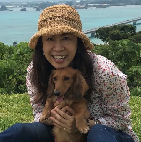 Photo of Rika with her miniature dachshund. 