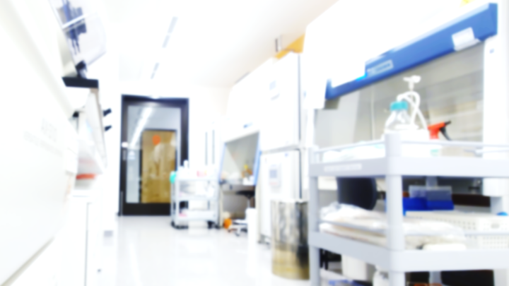 A room with biosafety cabinets and racks with small equipment