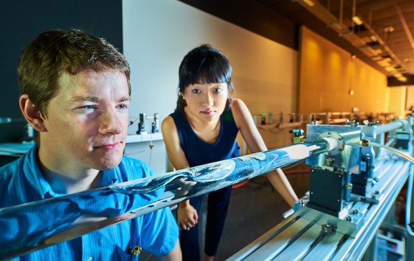 Researchers working on lab equipment