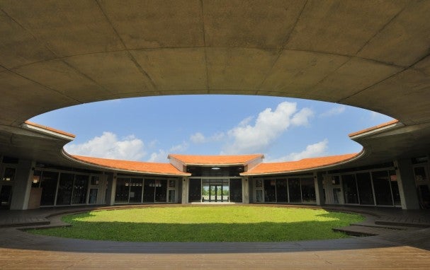 Red-roofed building and grass field