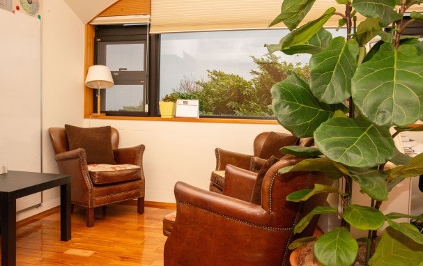 Arm chairs and a table in a room