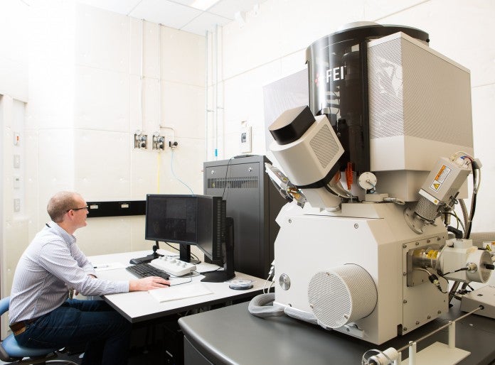 Staff operating a focused ion beam SEM 