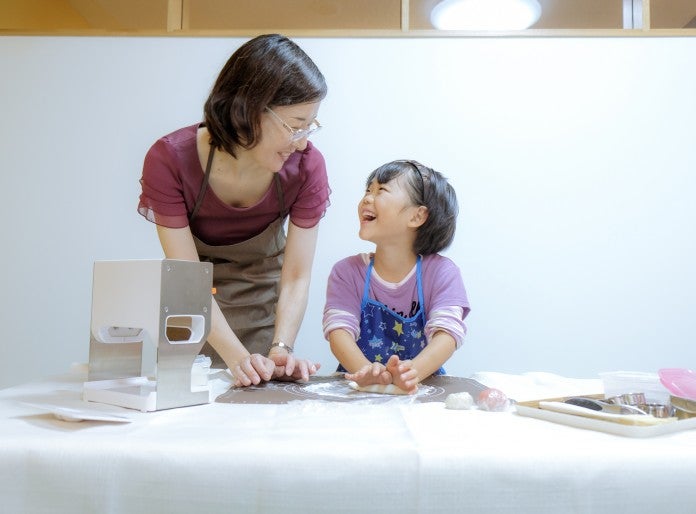 Adult and child smile at each other
